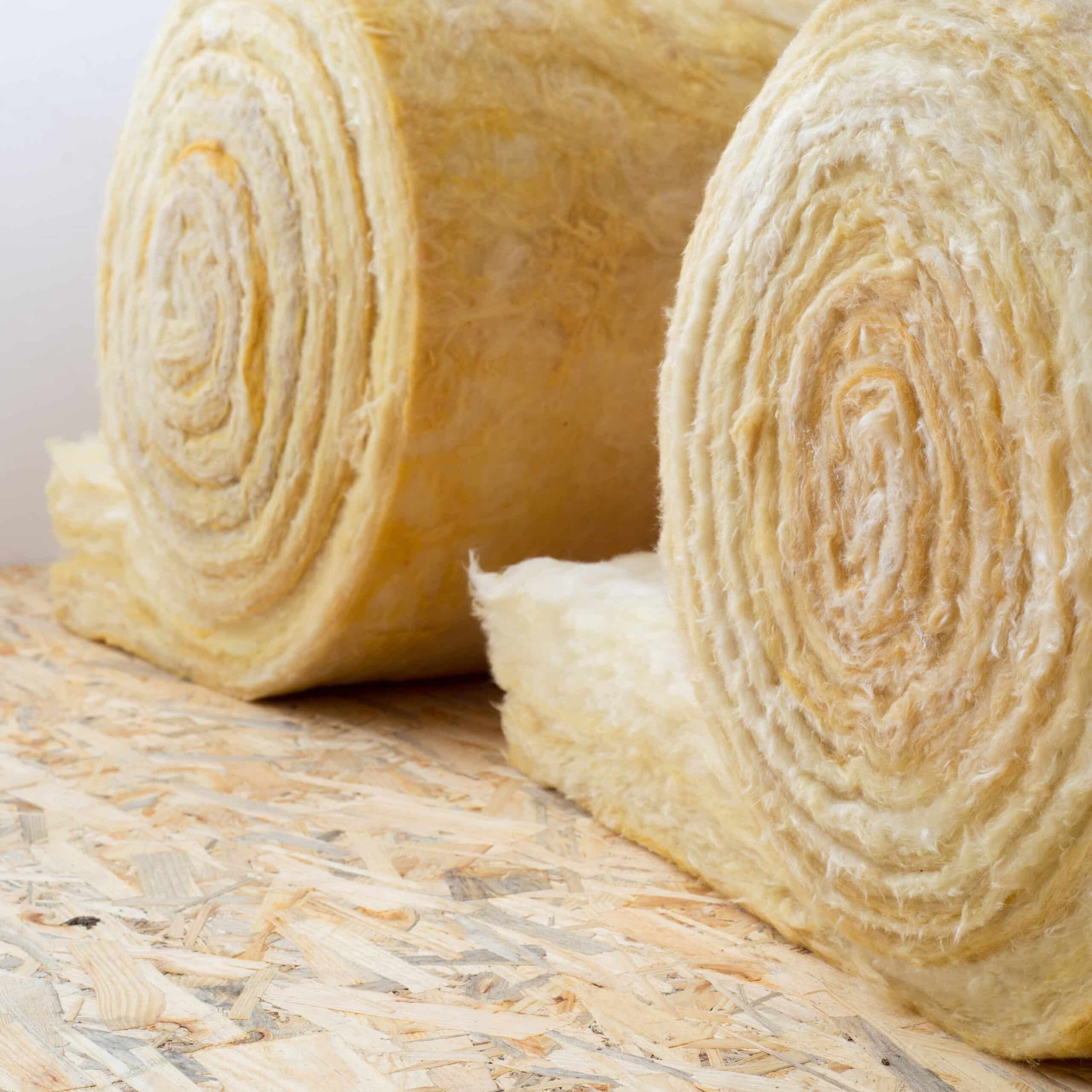 roll of mineral wool lying on the wooden floor